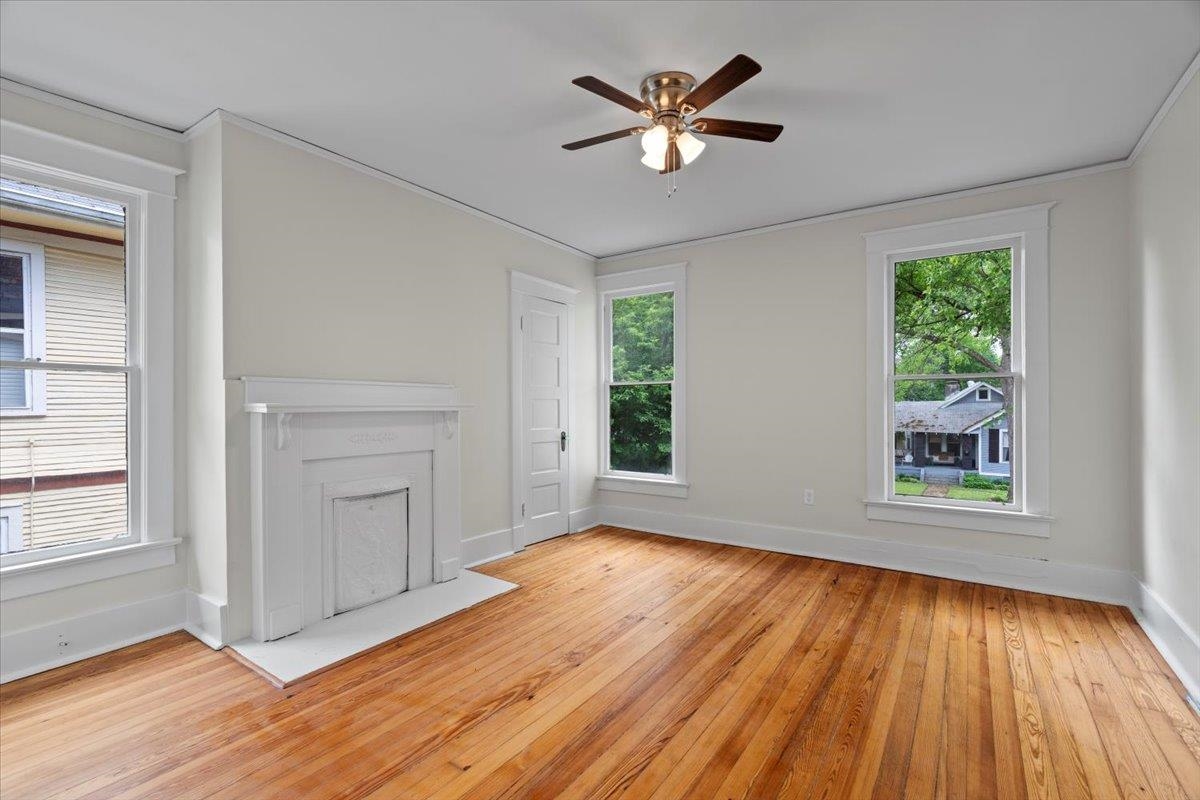 1682 Lawrence Avenue Memphis, TN 38112 - Photo 25 of 33 an empty room with wooden floor and windows