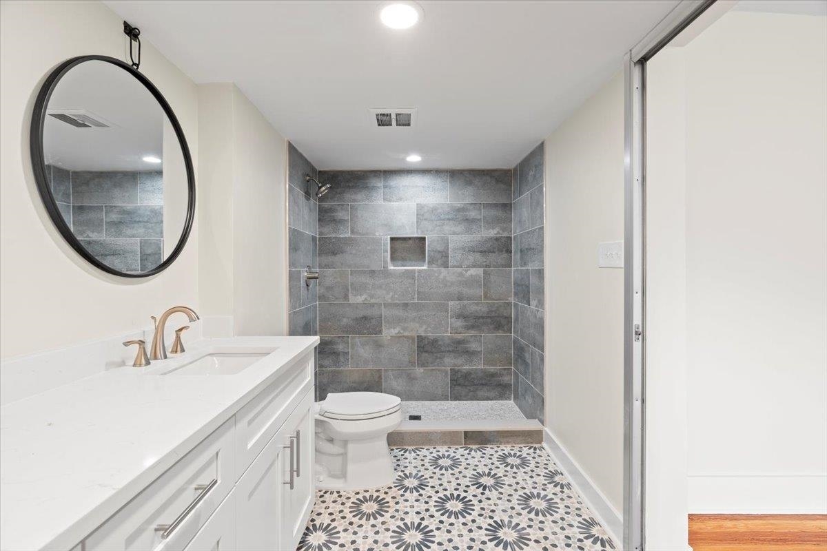 1682 Lawrence Avenue Memphis, TN 38112 - Photo 7 of 33 a bathroom with a sink a toilet and a mirror