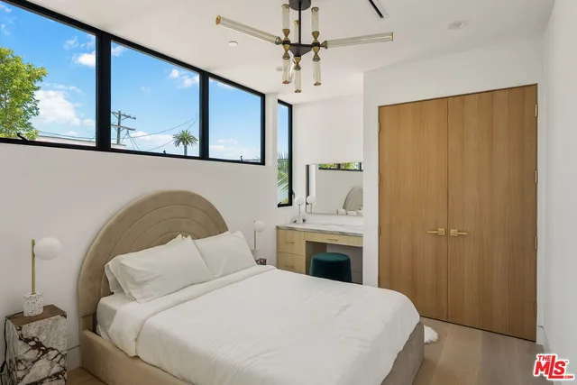 a bedroom with a bed and a dresser