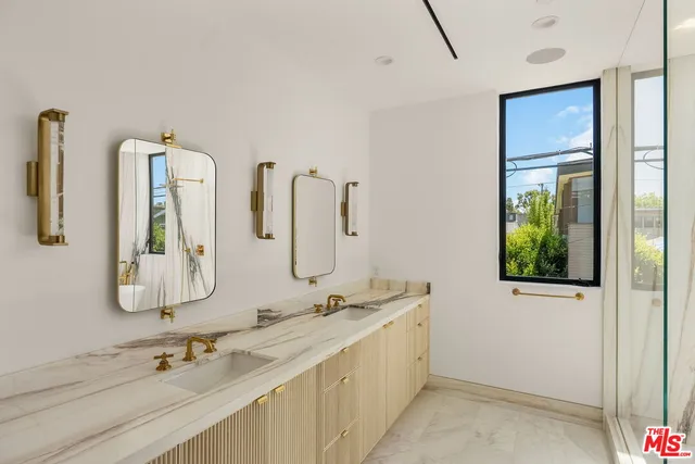 a bathroom with 2 sink and a mirror