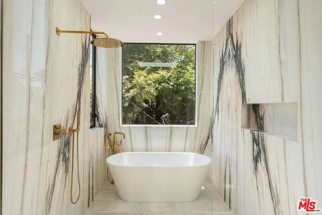 a spacious bathroom with a bathtub and shower