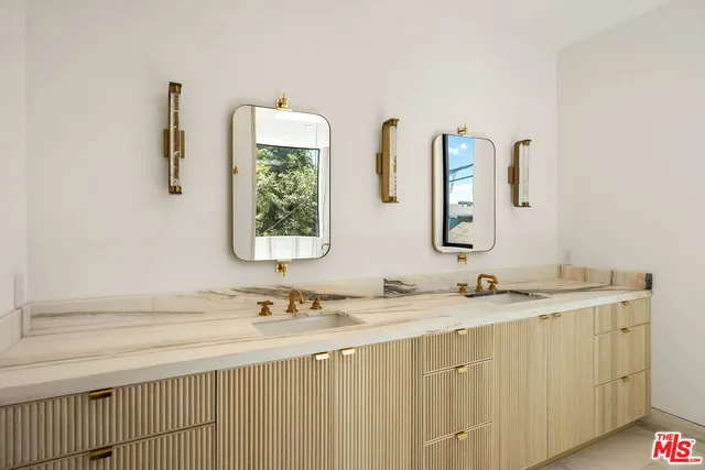 a bathroom with a double vanity sink and mirror