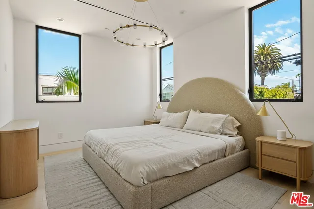 a bedroom with a bed and a painting on the wall