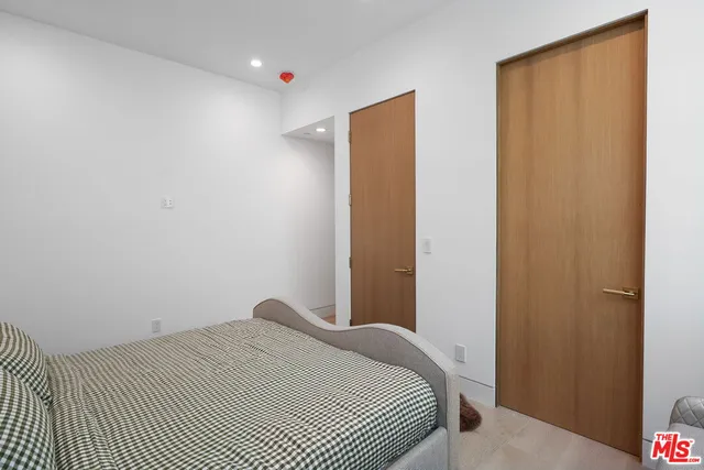 a bedroom with a bed and a mirror