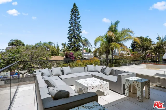 a view of a terrace with couches and sky view