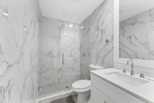 a bathroom with a sink toilet and shower