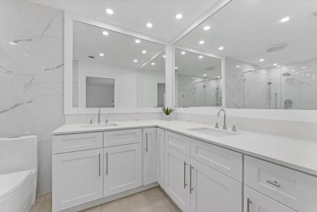 a bathroom with a double vanity sink and a mirror