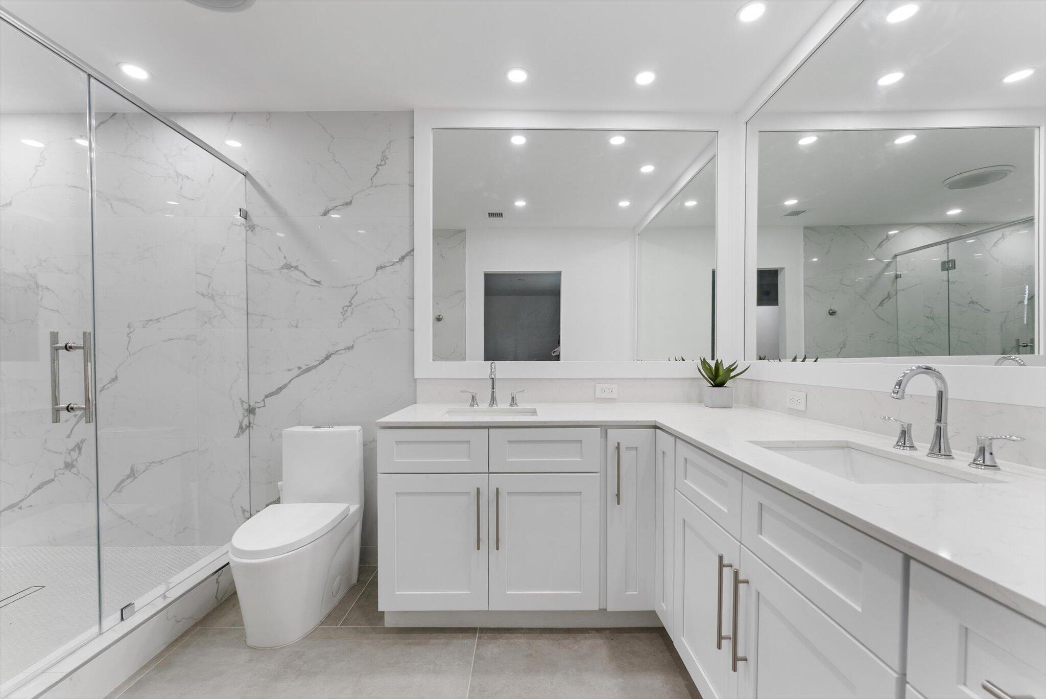 521 Northeast 32nd Street Boca Raton, FL 33431 - Photo 17 of 25 a bathroom with a double vanity sink mirror and toilet