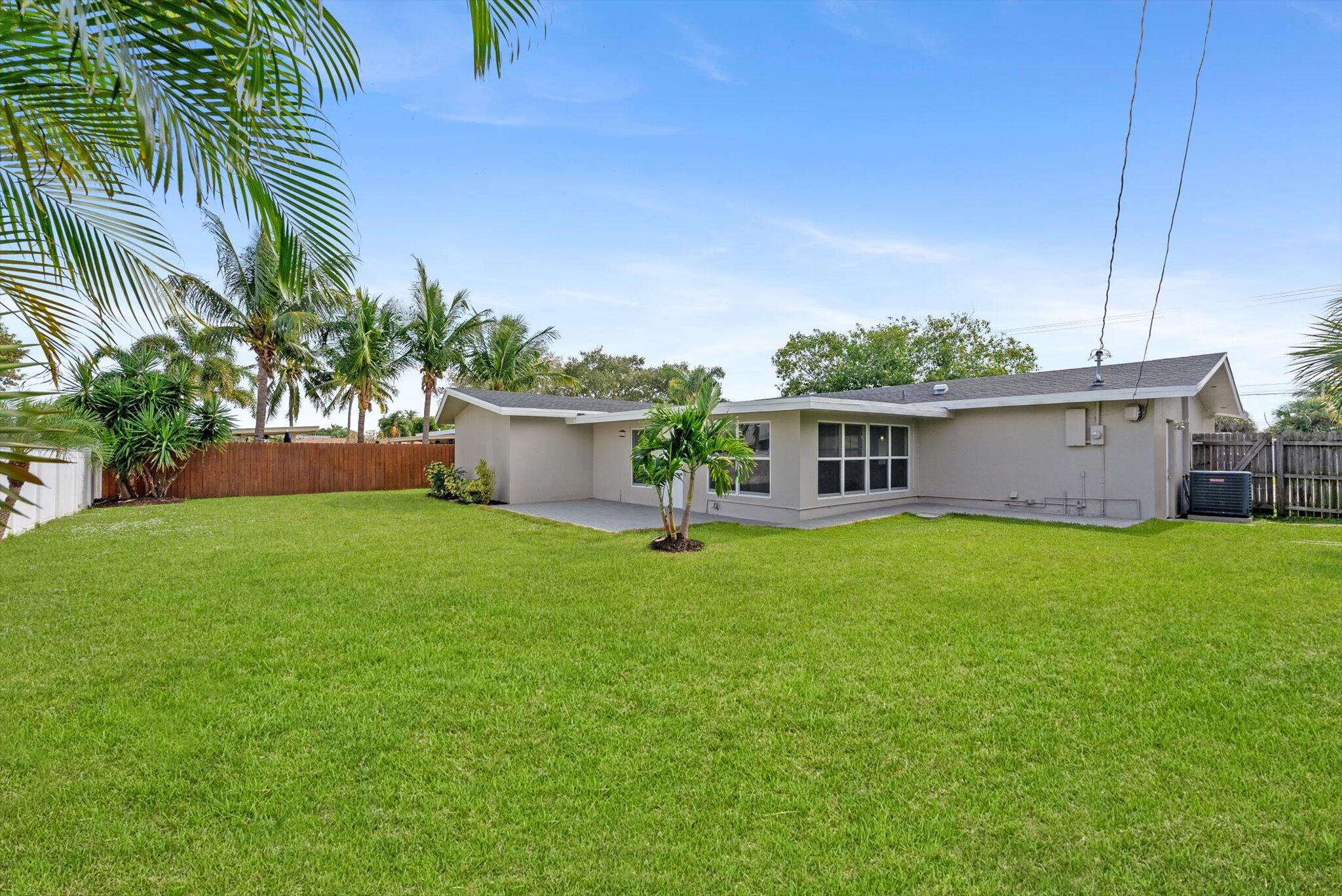 521 Northeast 32nd Street Boca Raton, FL 33431 - Photo 21 of 25 a view of a house with a backyard