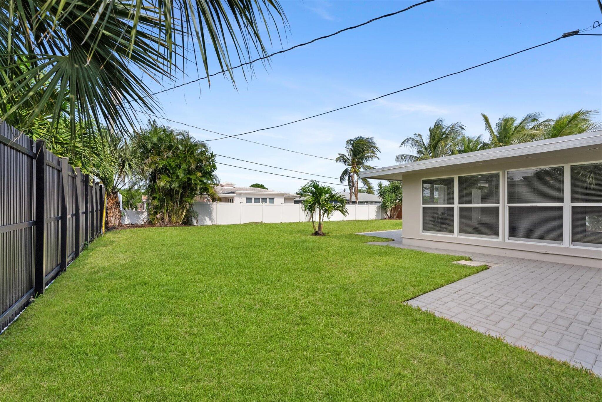 521 Northeast 32nd Street Boca Raton, FL 33431 - Photo 22 of 25 a view of a house with a yard