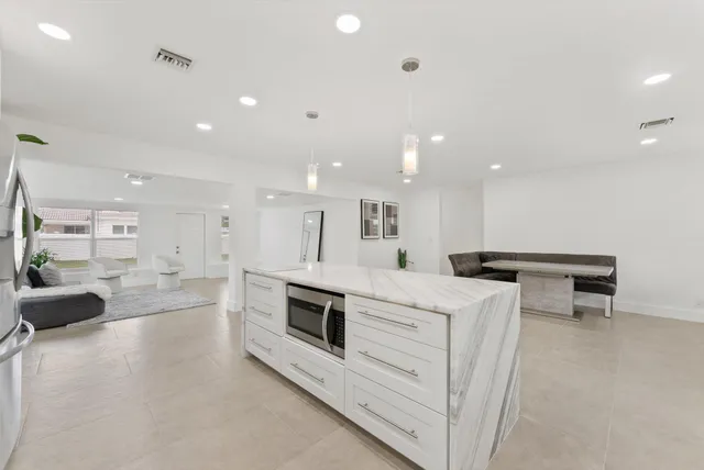 a kitchen with a stove a refrigerator and a sink