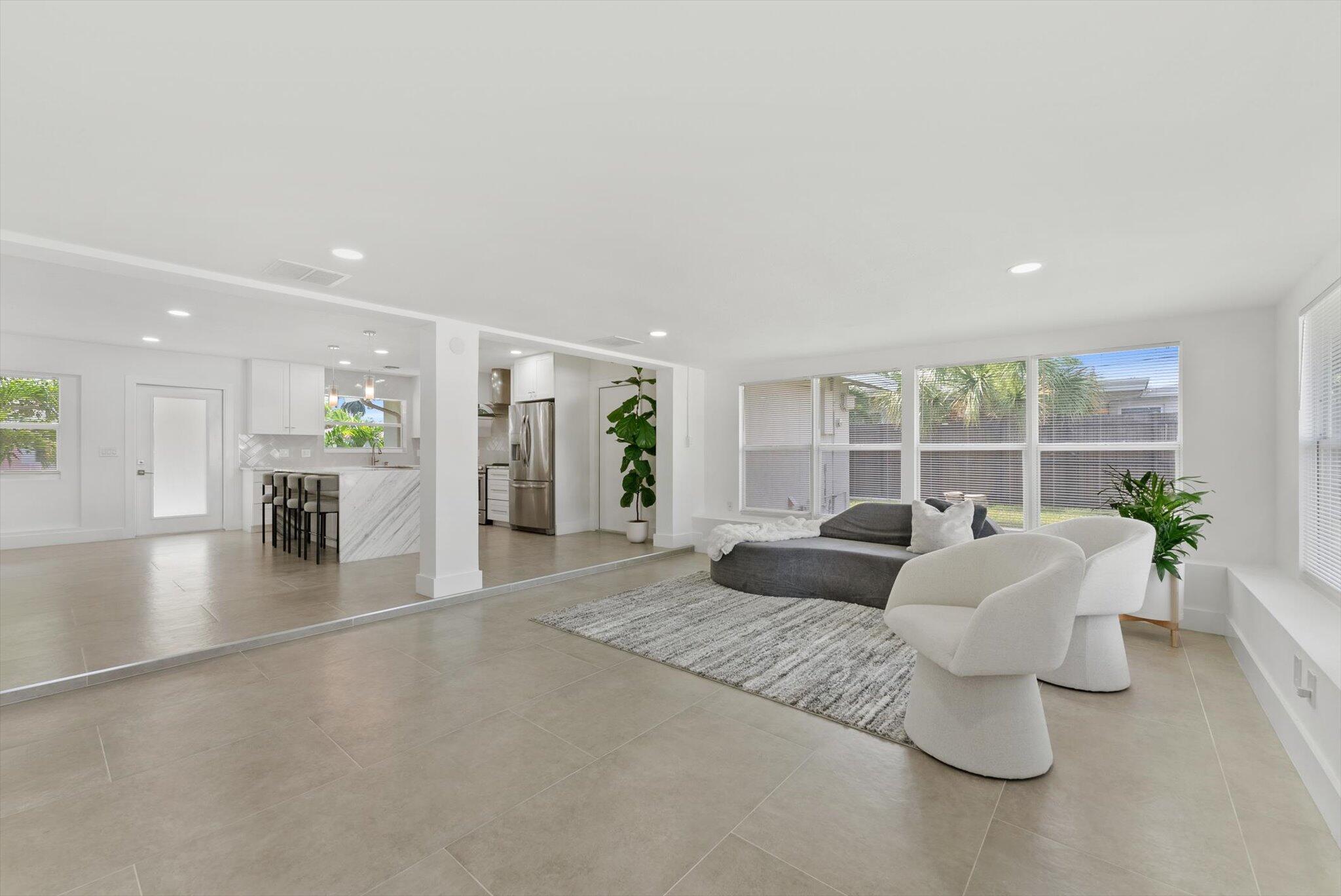 521 Northeast 32nd Street Boca Raton, FL 33431 - Photo 9 of 25 a living room with furniture and large windows