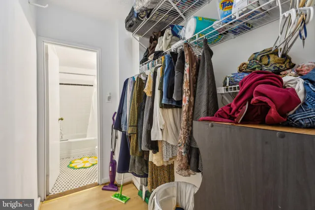 a view of walk in closet with clothes