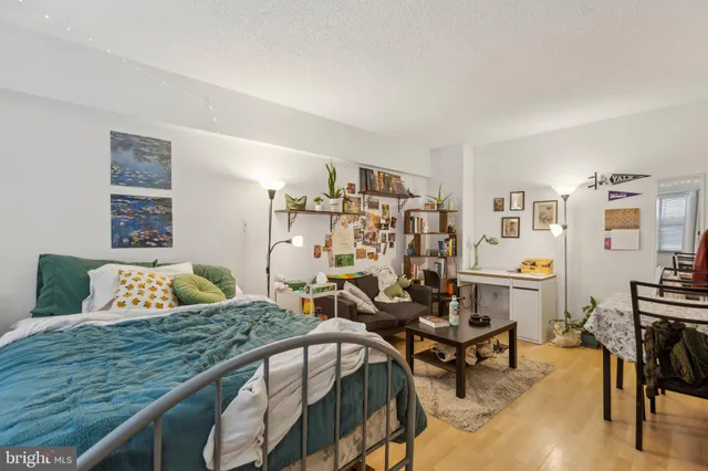 a bedroom with a bed a table and chair