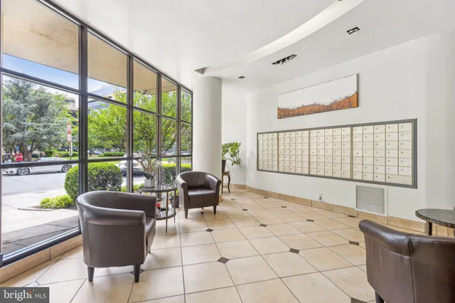 a bedroom with a bed and a refrigerator