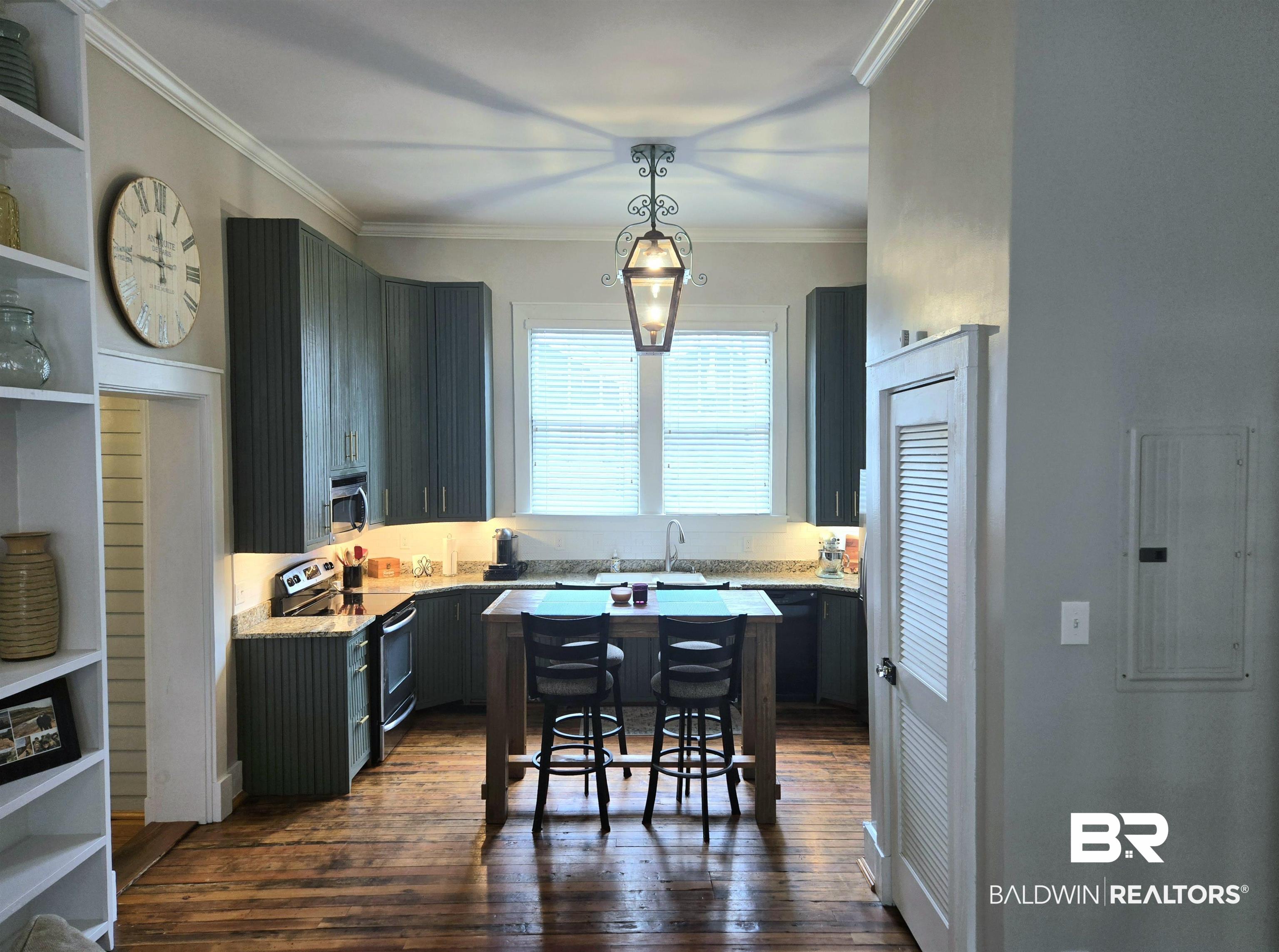 54 South Catherine Street Mobile, AL 36604 - Photo 19 of 55 Kitchen featuring stainless steel appliances, gray cabinets, crown molding, dark wood-style floors, and pendant lighting