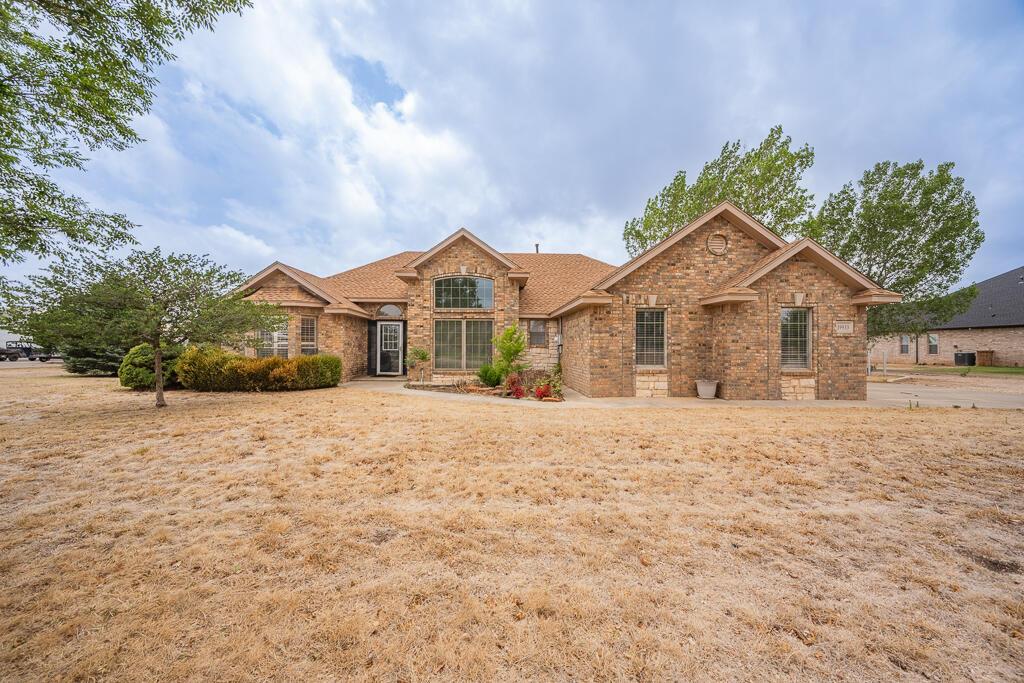 19933 Indian Spring Trail Bushland, TX 79124 - Photo 3 of 32 a front view of a house with a yard and garage