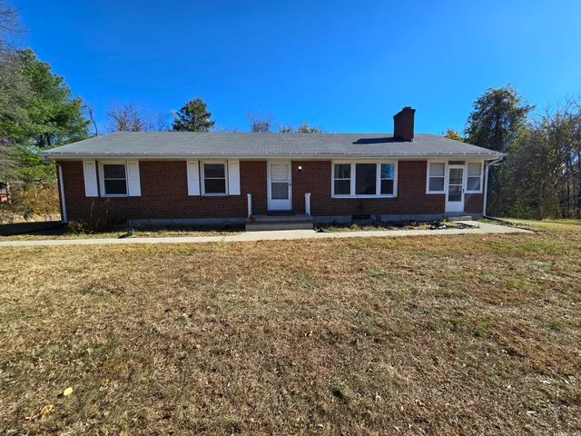 a front view of a house with yard