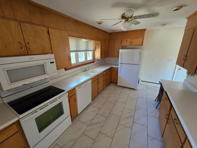 a kitchen with a stove sink and cabinets