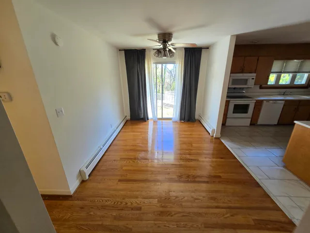 a view of a hallway view with wooden floor and staircase