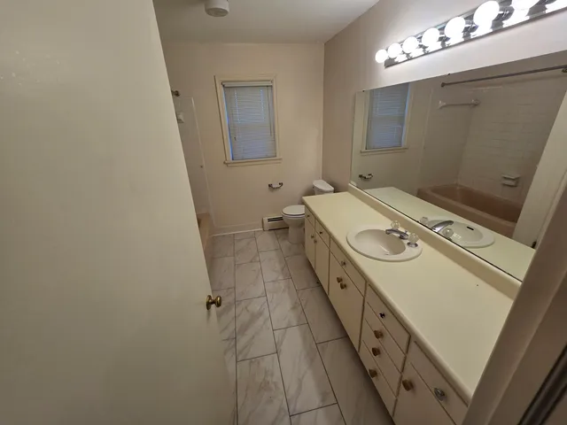 a bathroom with a glass shower door