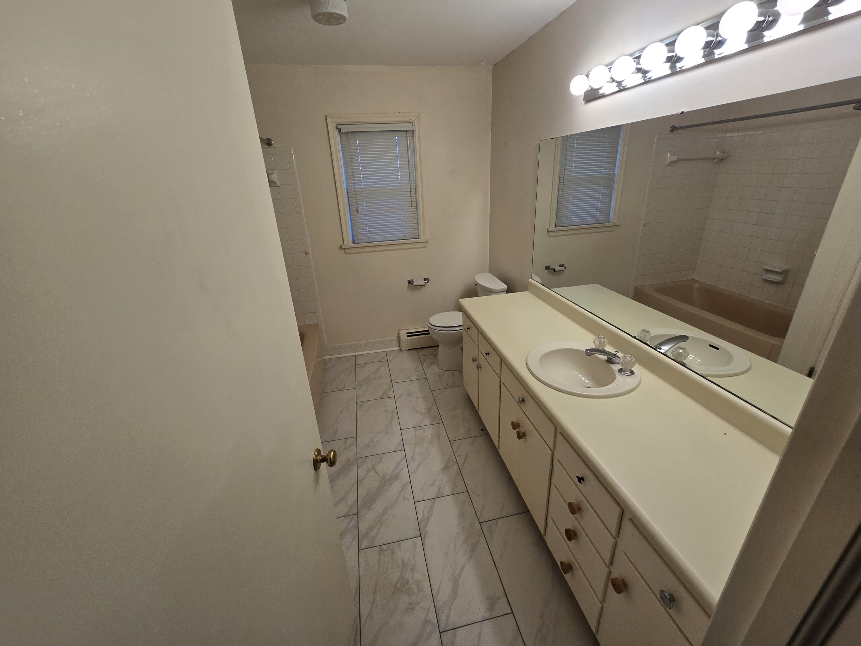 3714 Bandy Road Roanoke, VA 24014 - Photo 7 of 17 a bathroom with a sink a toilet and mirror