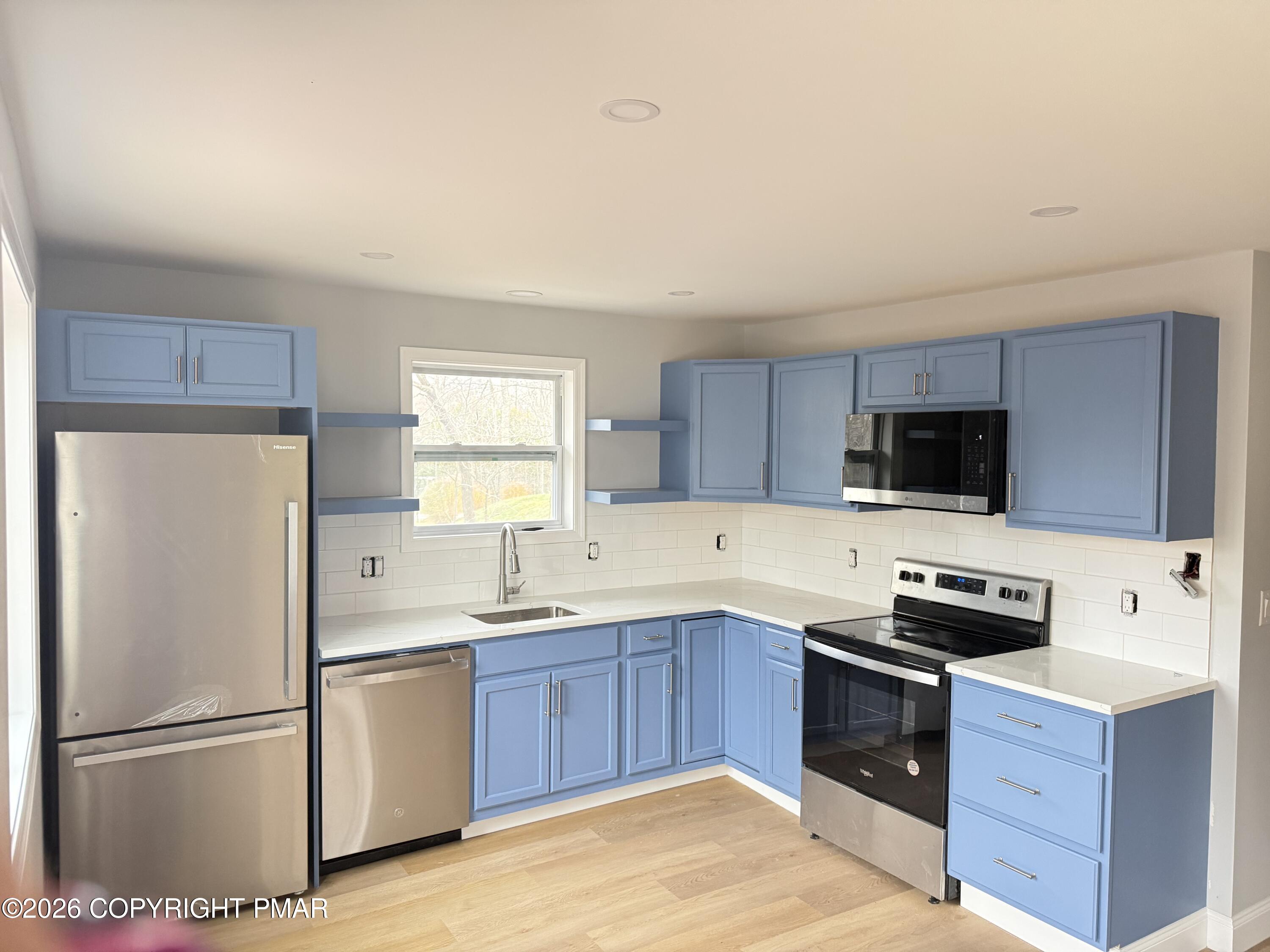 3106 Mohawk Trail Tobyhanna, PA 18466 - Photo 3 of 13 a kitchen with a refrigerator sink and microwave
