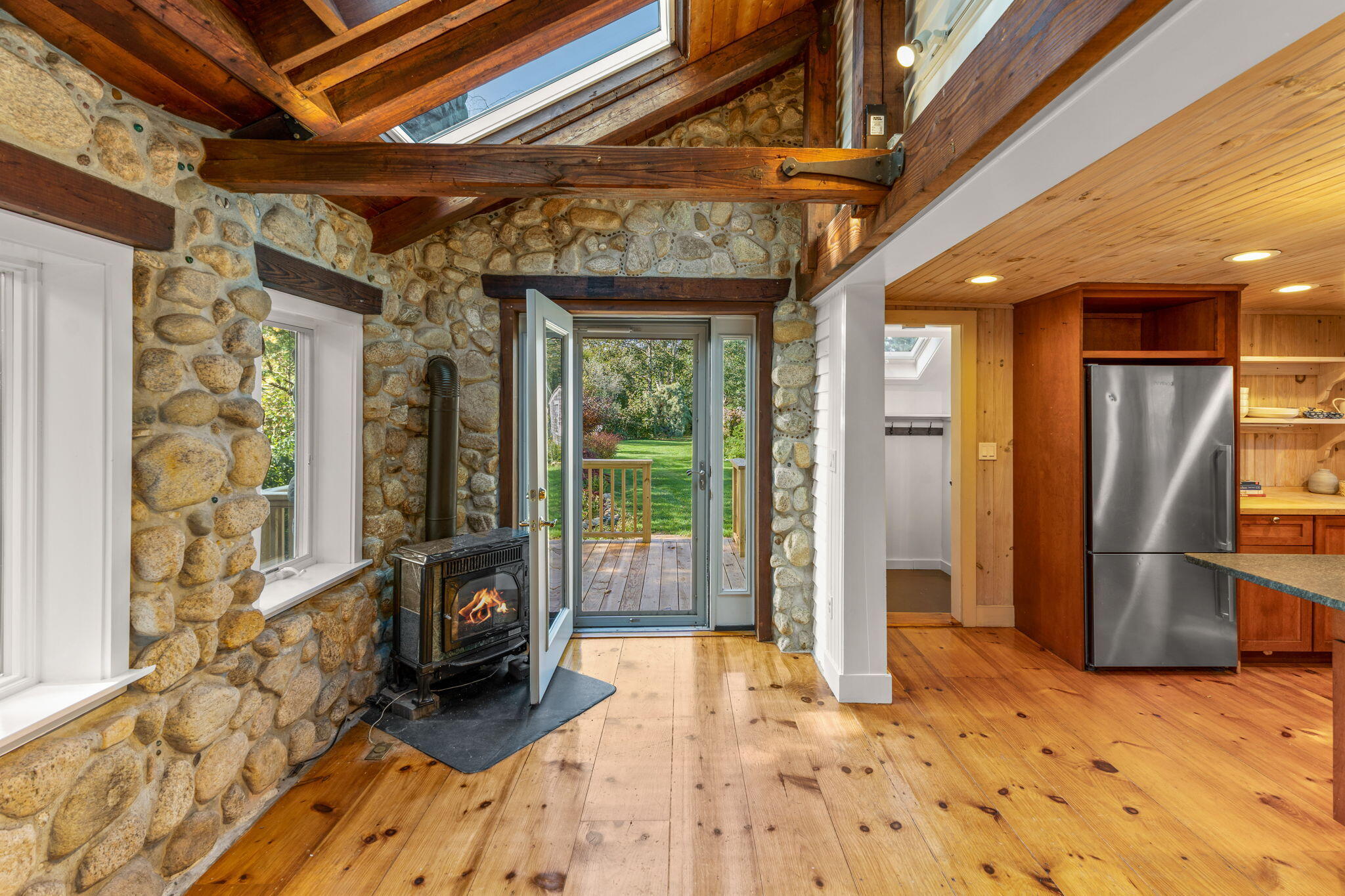 1208 County Road Cataumet, MA 02534 - Photo 11 of 40 a view of a hallway with wooden floor and a glass door