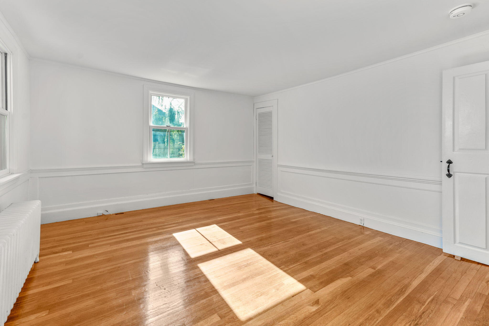1208 County Road Cataumet, MA 02534 - Photo 18 of 40 a view of empty room with wooden floor and fan