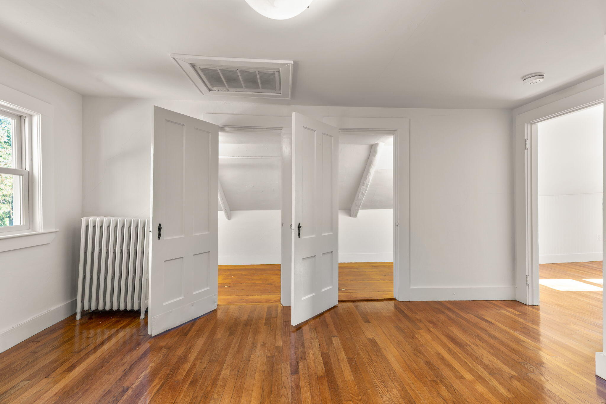 1208 County Road Cataumet, MA 02534 - Photo 22 of 40 a view of empty room with wooden floor and fan