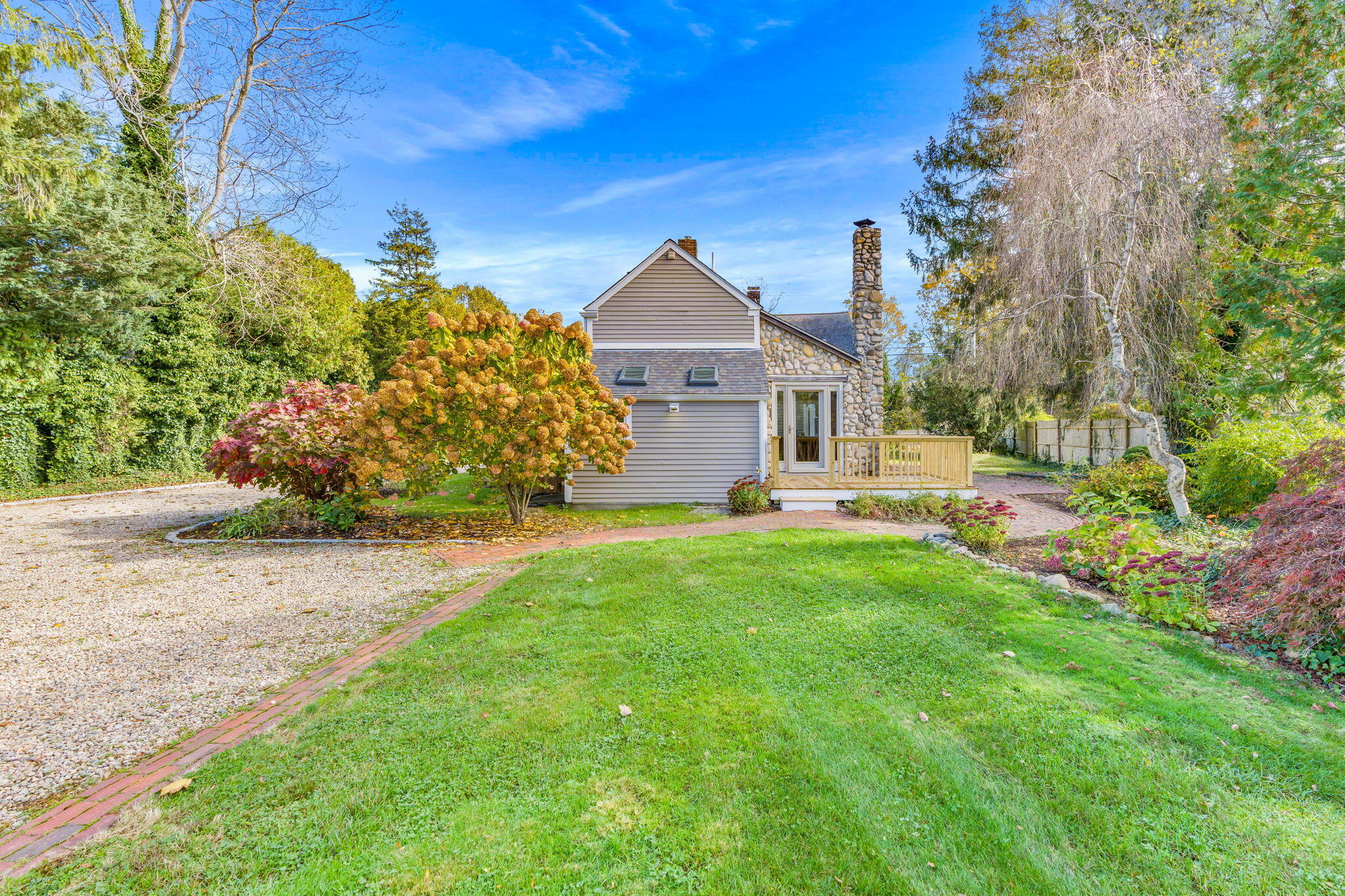 1208 County Road Cataumet, MA 02534 - Photo 25 of 40 a front view of a house with a garden and yard