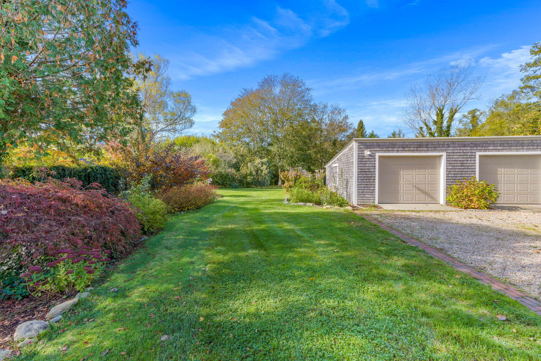 1208 County Road Cataumet, MA 02534 - Photo 28 of 40 a view of a house with a yard and a garden