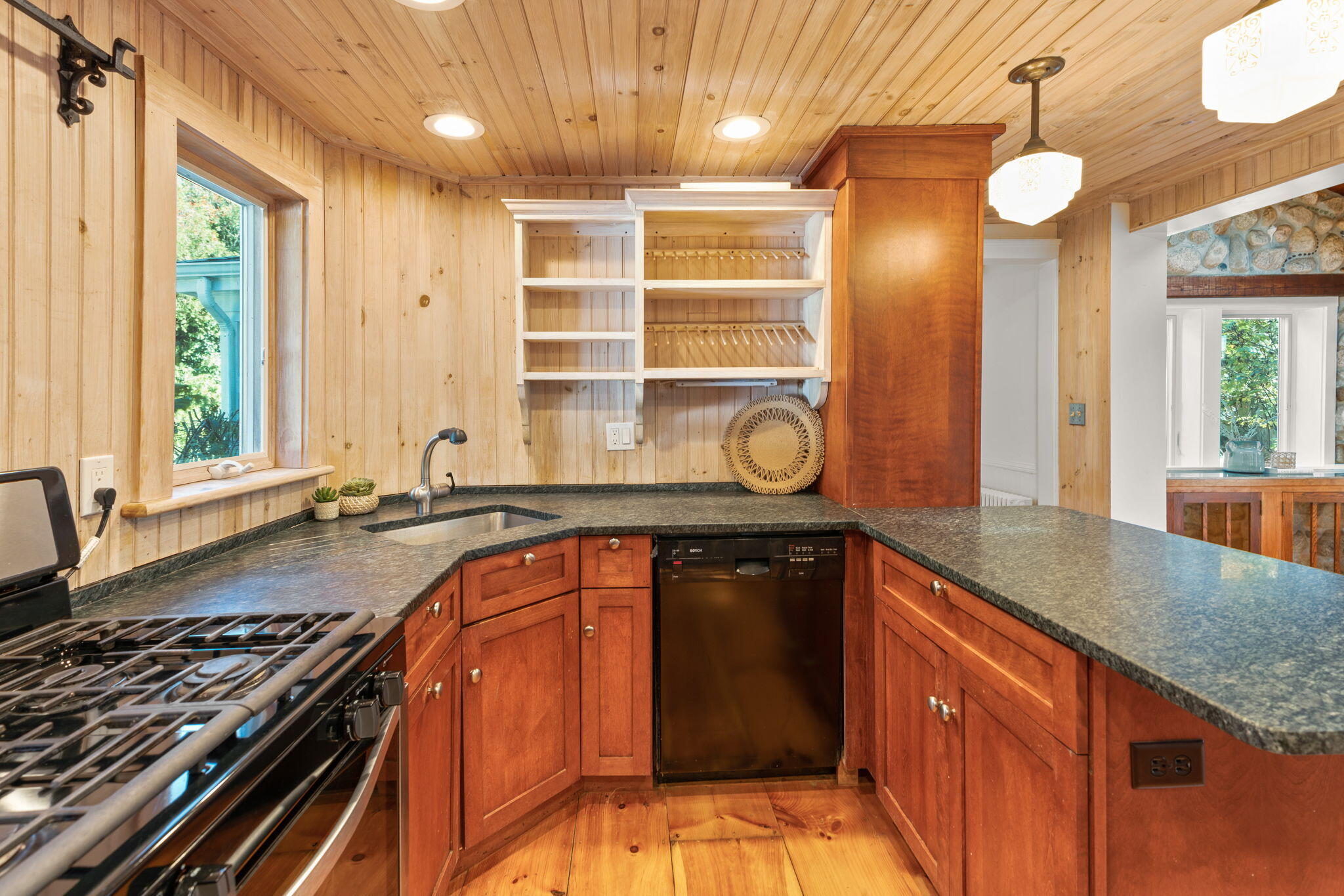1208 County Road Cataumet, MA 02534 - Photo 9 of 40 a kitchen with wooden cabinets and a stove