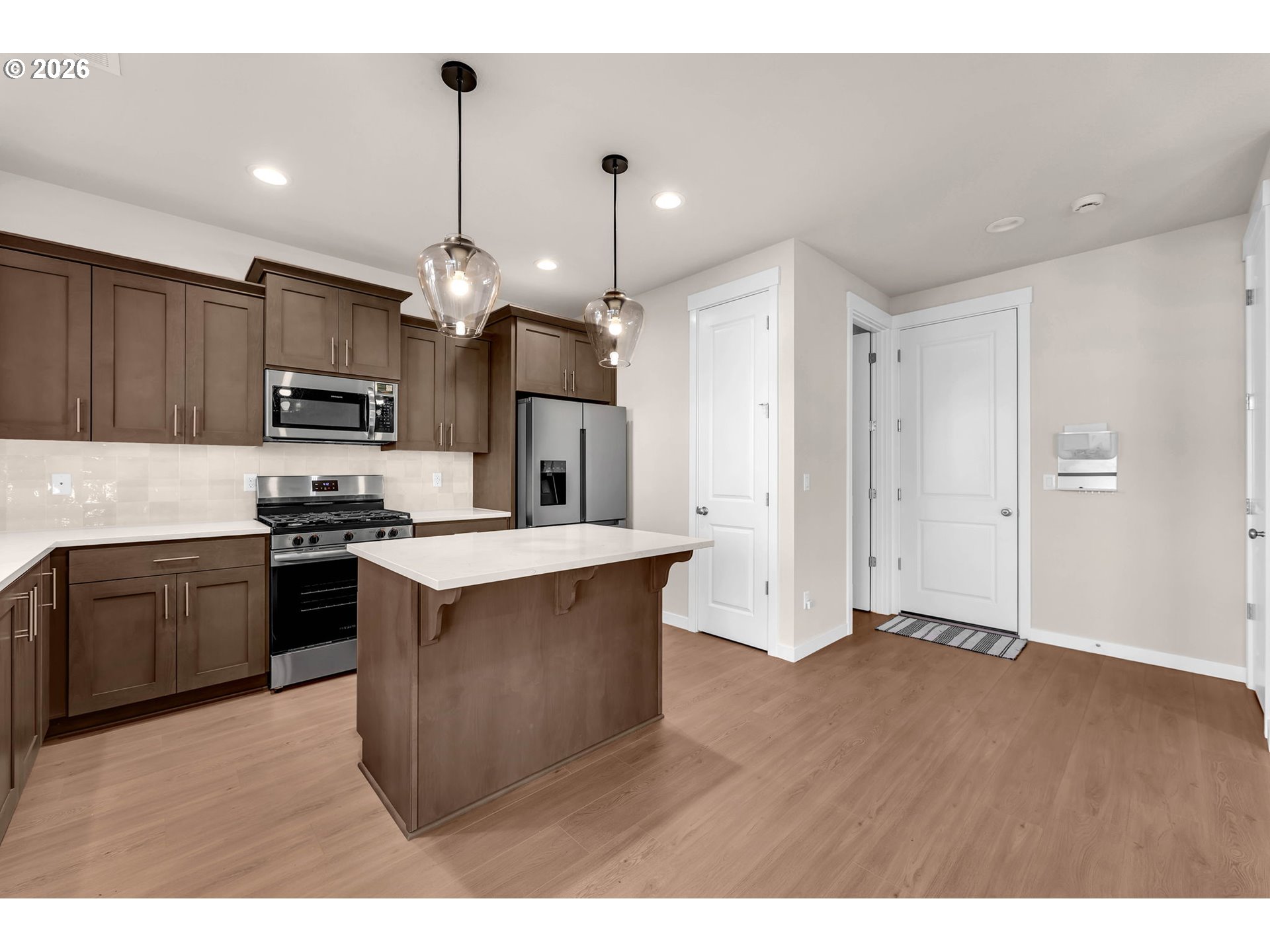 4308 Northeast 185th Street Vancouver, WA 98686 - Photo 11 of 41 a kitchen with kitchen island granite countertop stainless steel appliances and wooden cabinets