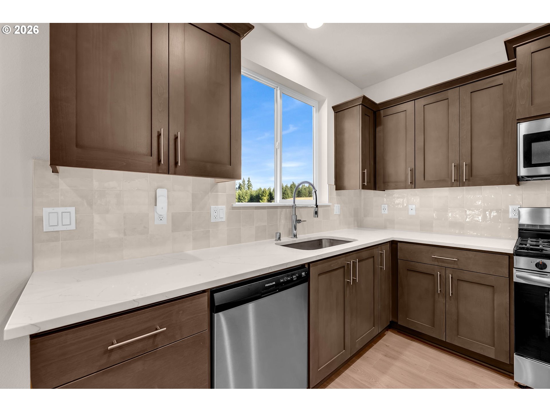 4308 Northeast 185th Street Vancouver, WA 98686 - Photo 12 of 41 a kitchen with a sink cabinets and wooden floor