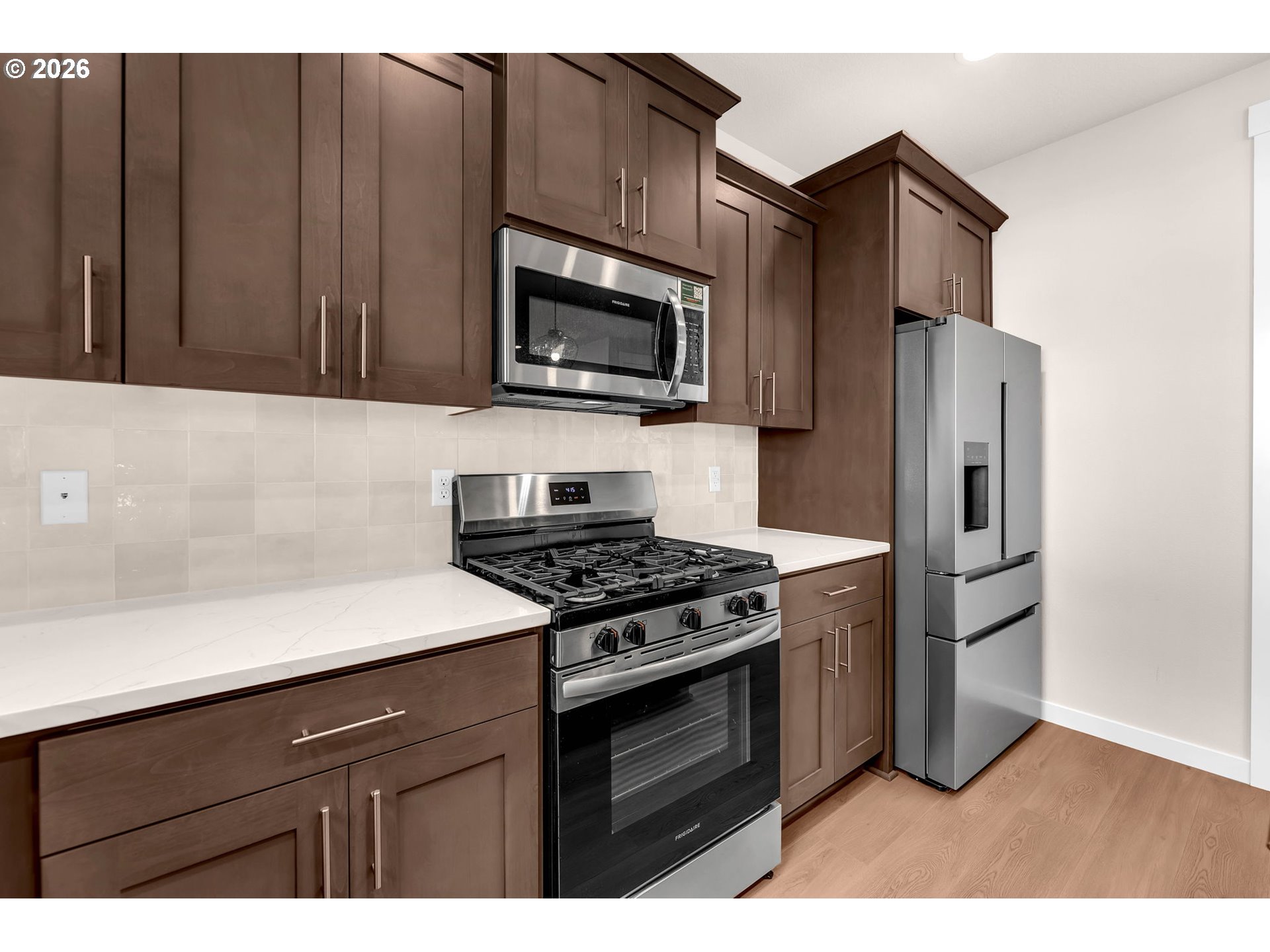 4308 Northeast 185th Street Vancouver, WA 98686 - Photo 14 of 41 a kitchen with stainless steel appliances a stove a microwave and a sink