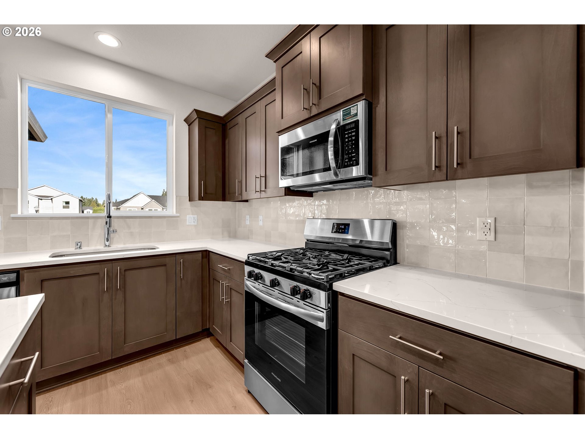 4308 Northeast 185th Street Vancouver, WA 98686 - Photo 17 of 41 a kitchen with stainless steel appliances granite countertop a sink stove and microwave