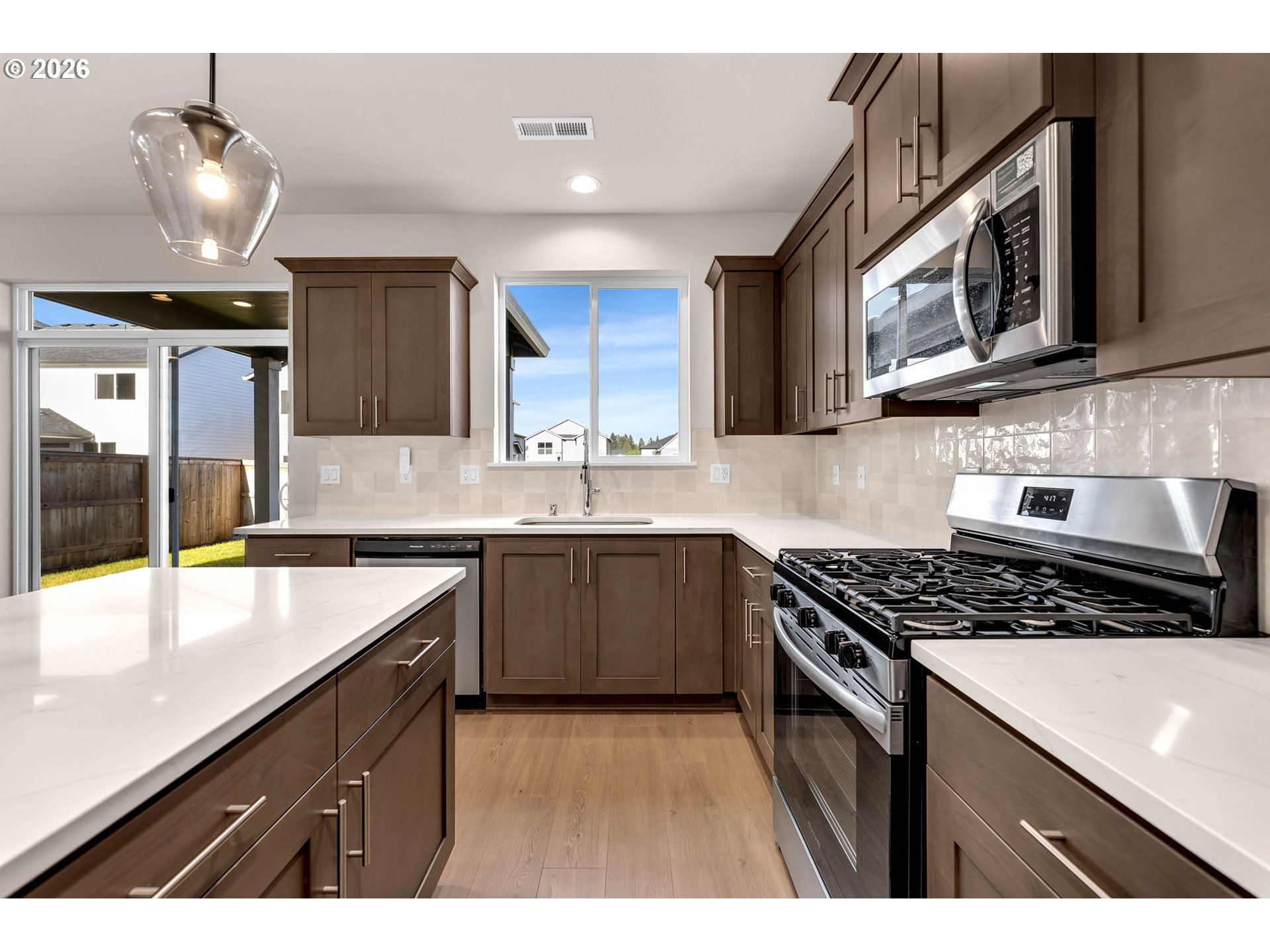 4308 Northeast 185th Street Vancouver, WA 98686 - Photo 18 of 41 a kitchen with stainless steel appliances granite countertop a sink a stove and a microwave