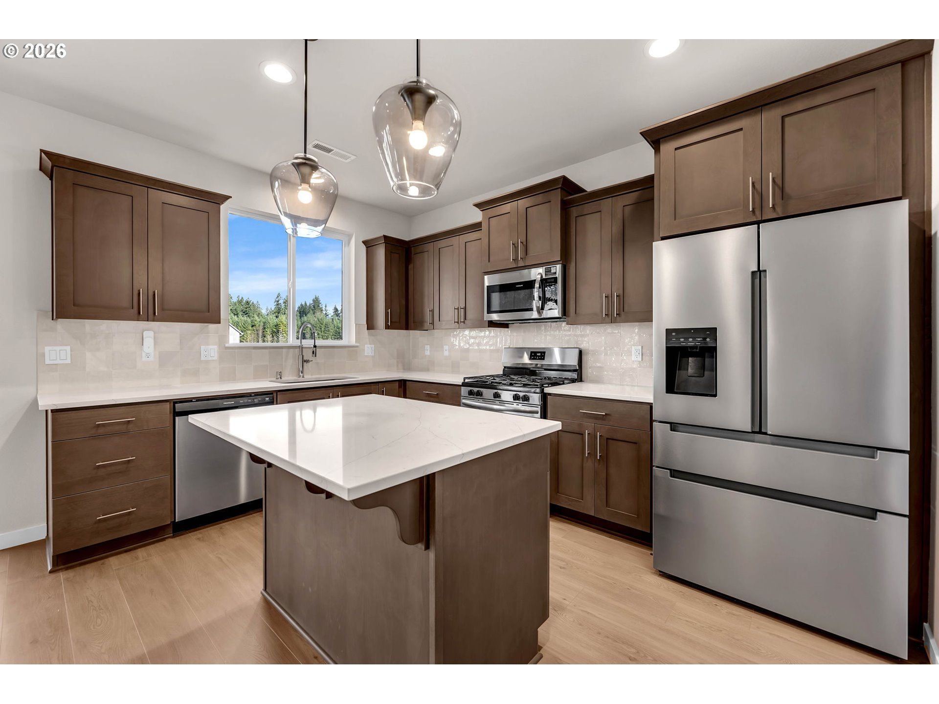 4308 Northeast 185th Street Vancouver, WA 98686 - Photo 19 of 41 a kitchen with kitchen island granite countertop stainless steel appliances cabinets a sink and a center island