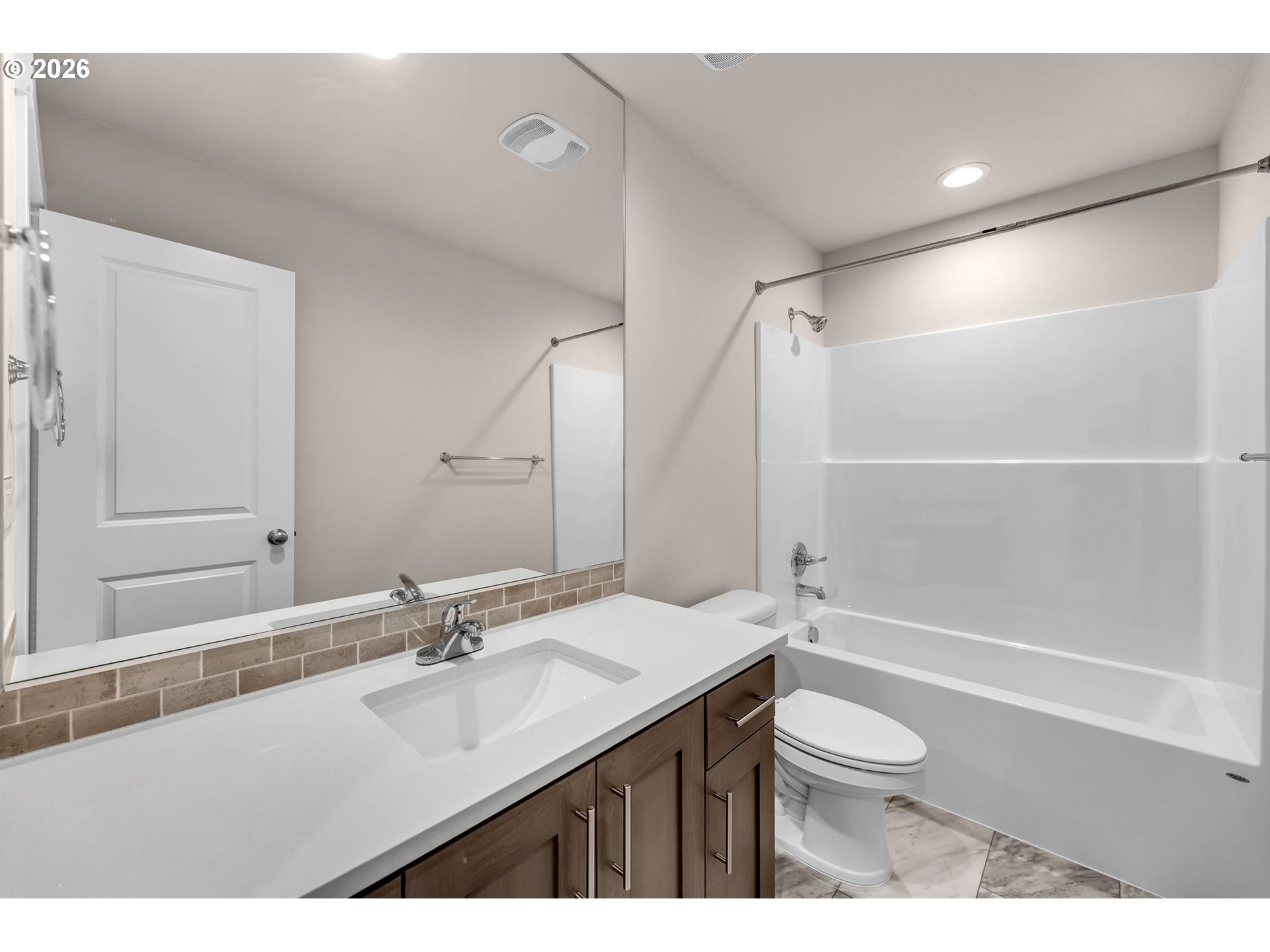 4308 Northeast 185th Street Vancouver, WA 98686 - Photo 32 of 41 a bathroom with a sink a toilet and a large mirror