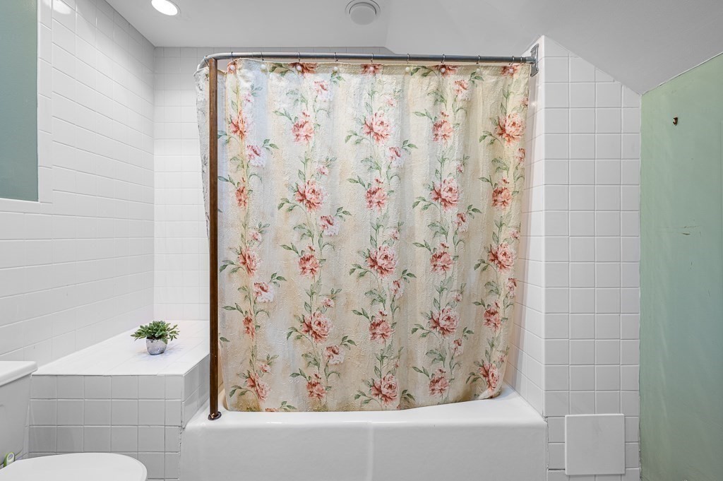 30 Draper Road Gardner, MA 01440 - Photo 31 of 41 a bathroom with a bathtub and shower curtain