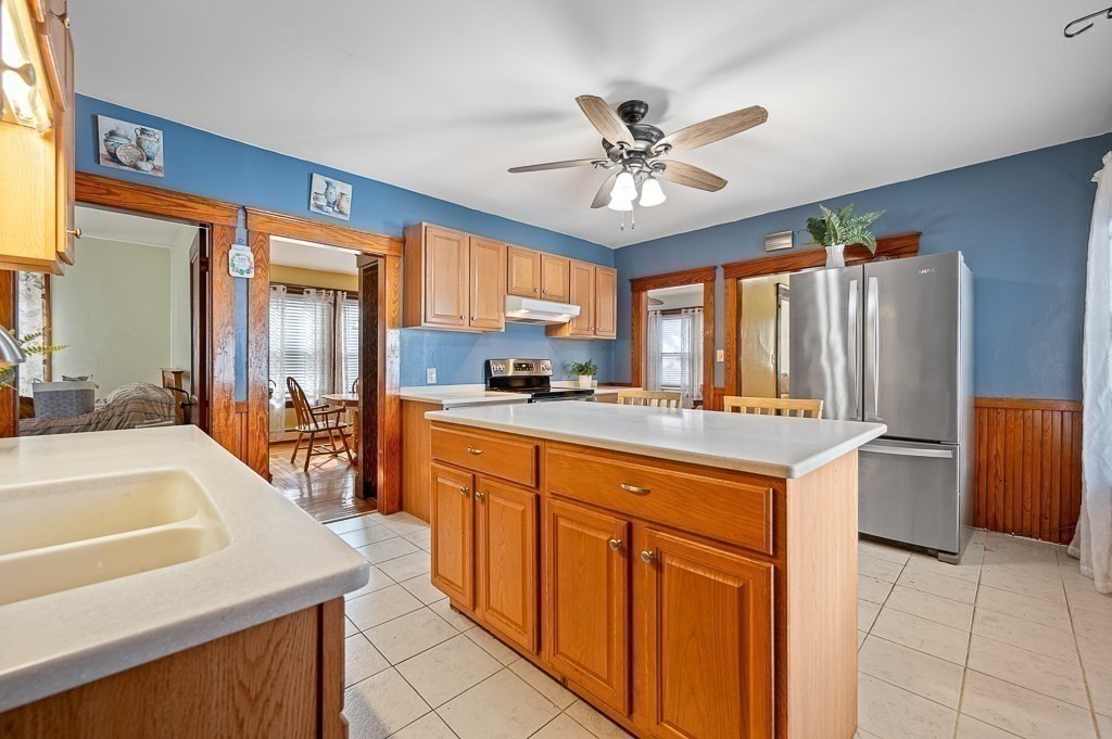 30 Draper Road Gardner, MA 01440 - Photo 7 of 41 a kitchen with stainless steel appliances a table chairs and a refrigerator