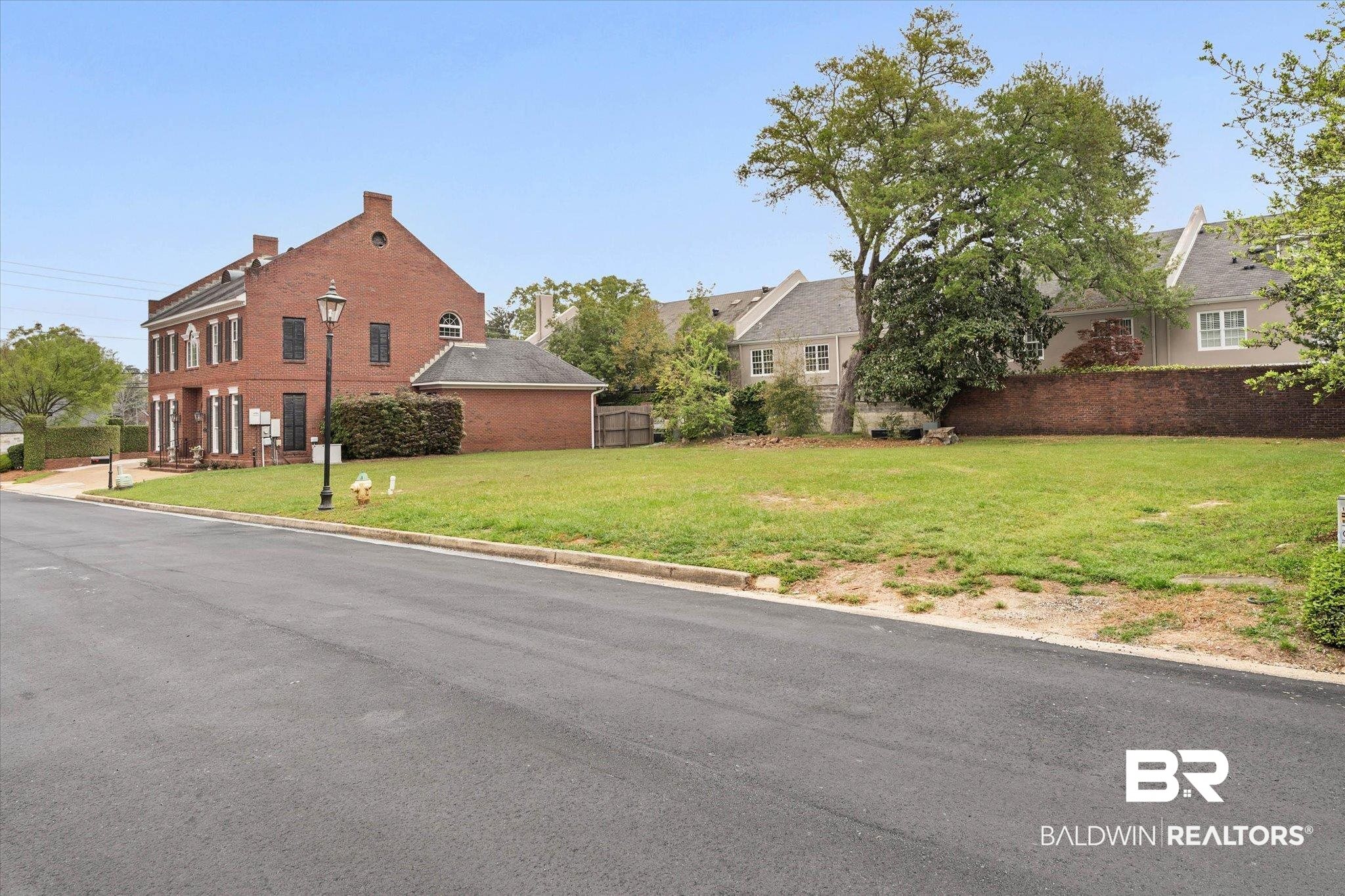 104 Fielding Place Mobile, AL 36608 - Photo 11 of 13 View of asphalt road featuring curbs, street lights, and a residential view