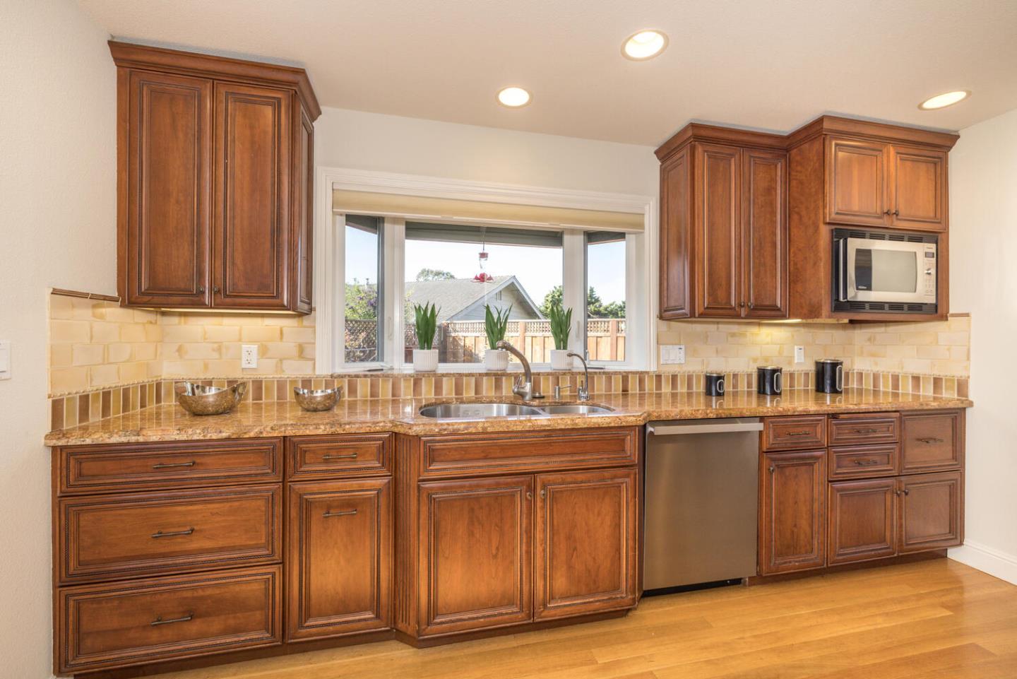2044 Touraine Lane Half Moon Bay, CA 94019 - Photo 3 of 53 a kitchen with stainless steel appliances granite countertop a sink a stove cabinets and wooden floor