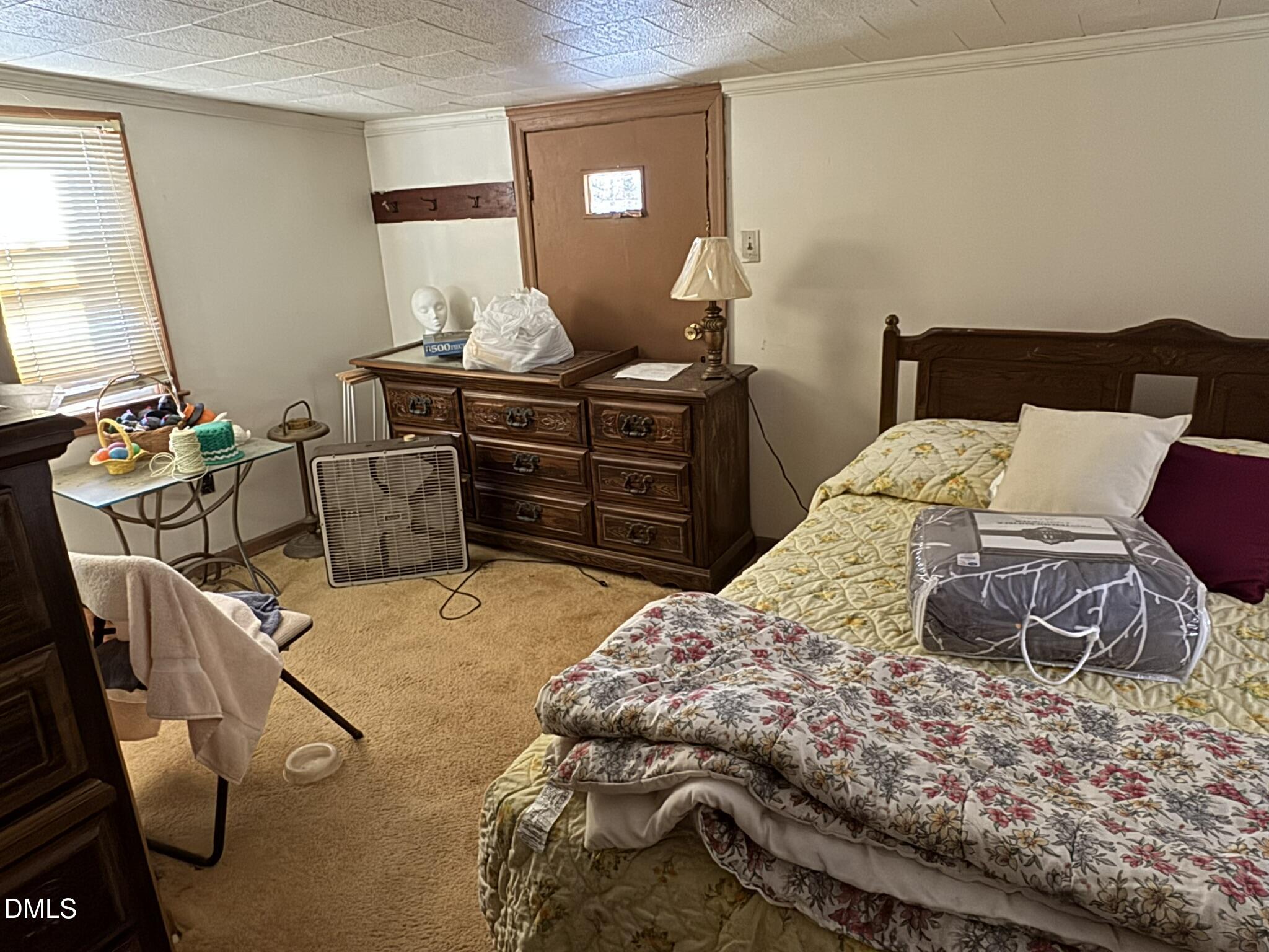 213 Hill Street Roxboro, NC 27573 - Photo 11 of 13 a bedroom with a bed and wooden floor