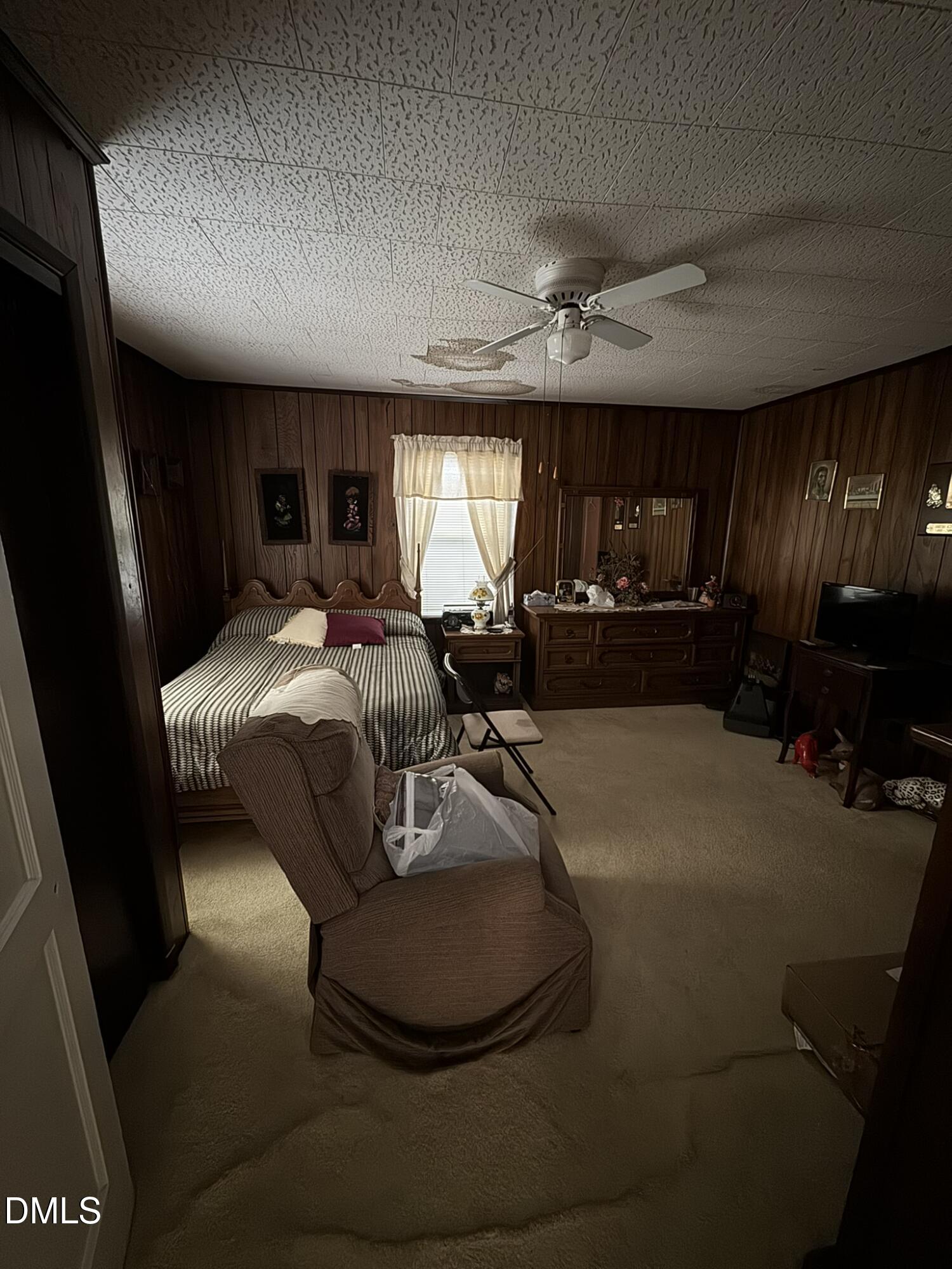213 Hill Street Roxboro, NC 27573 - Photo 4 of 13 a room with a bed mirror furniture and a window