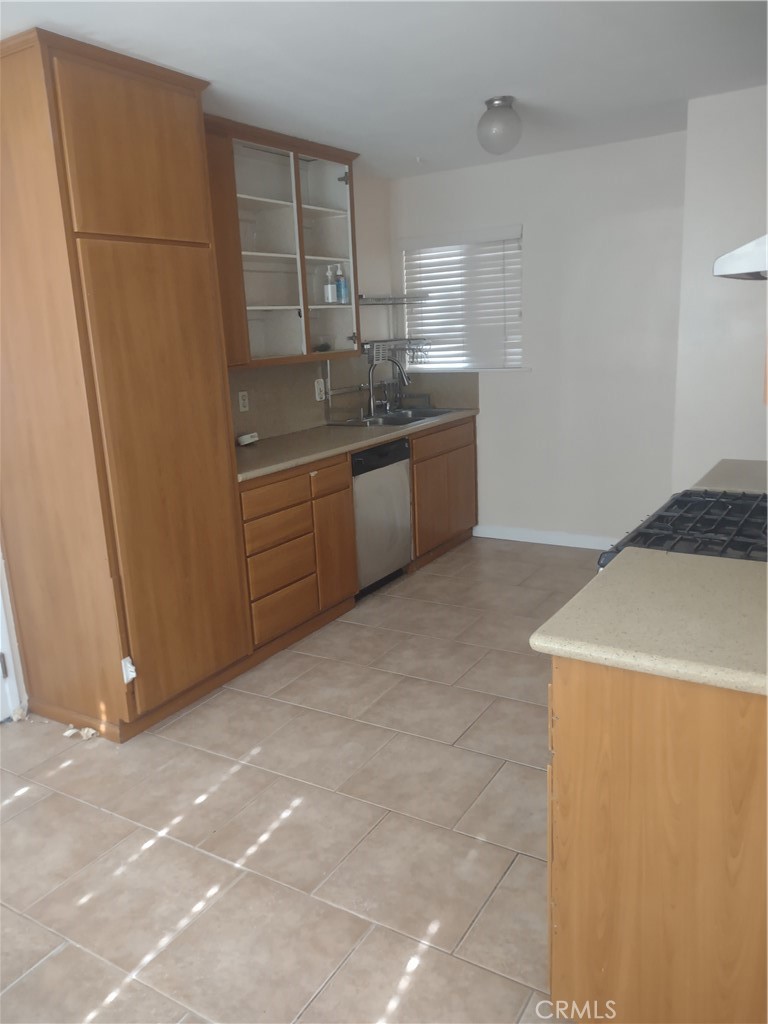313 Muir Street Barstow, CA 92311 - Photo 7 of 9 a kitchen with stainless steel appliances a refrigerator sink and cabinets