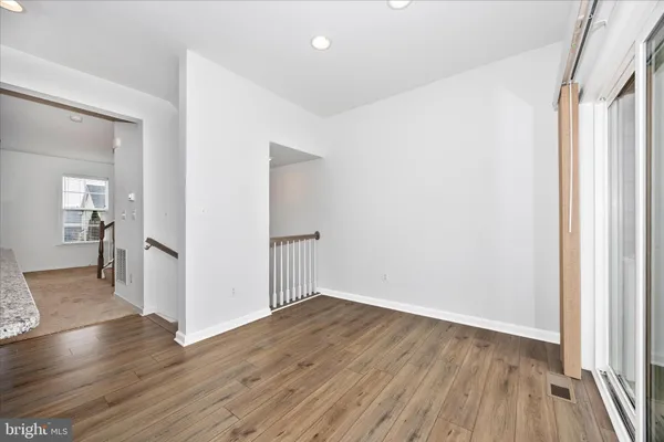 a kitchen with stainless steel appliances granite countertop a refrigerator a stove top oven and a sink with granite countertops