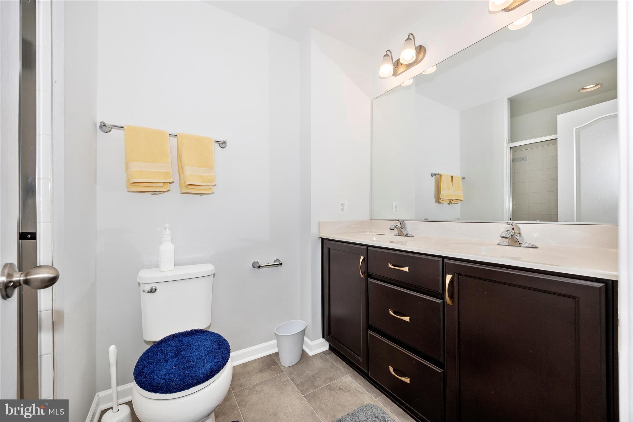 205 Union Ridge Drive Charles Town, WV 25414 - Photo 31 of 56 a bathroom with a toilet a sink and mirror