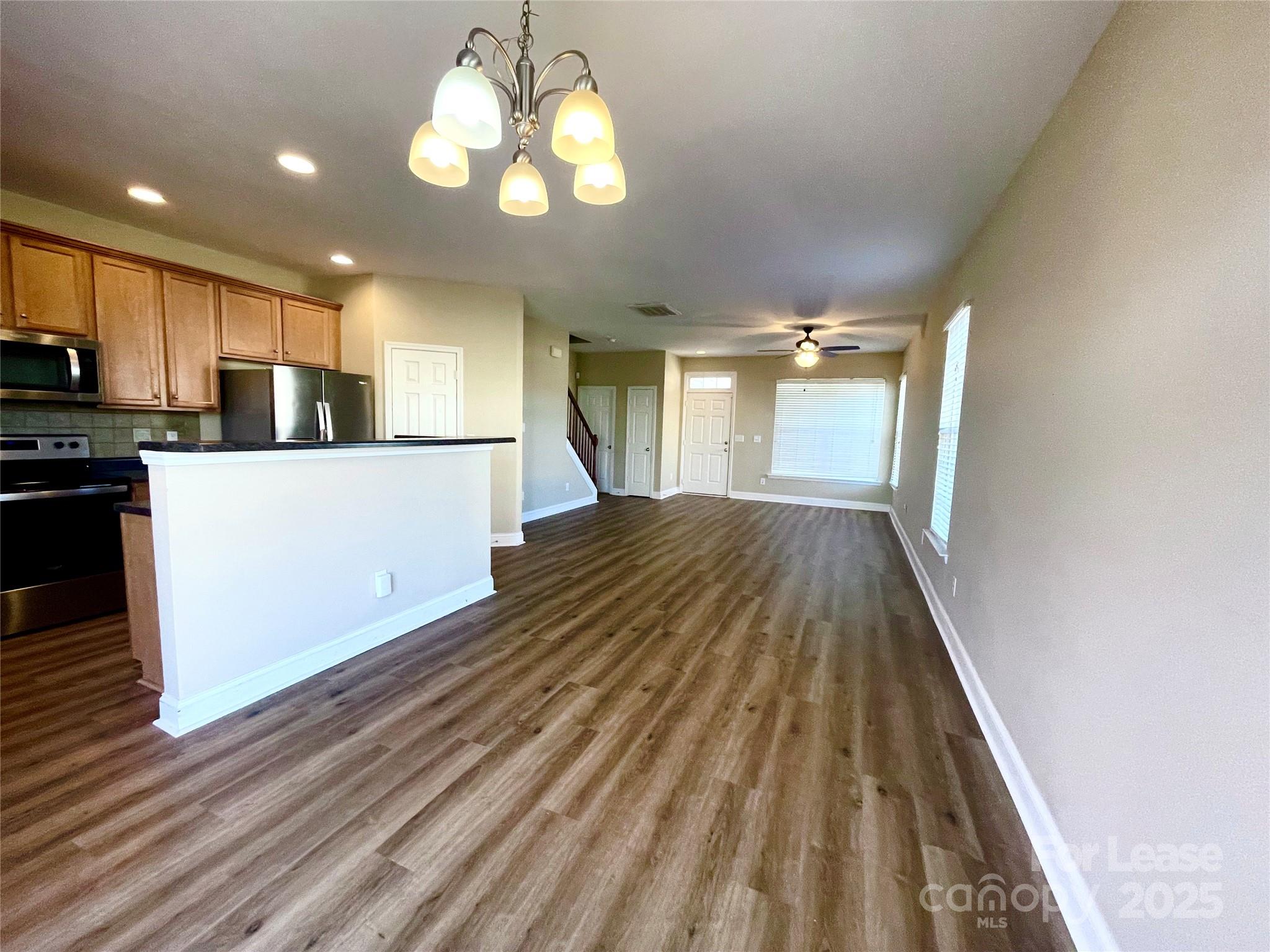 233 East Waterlynn Road, Unit A Mooresville, NC 28117 - Photo 4 of 13 a view of a kitchen with a sink and dishwasher a refrigerator with wooden floor